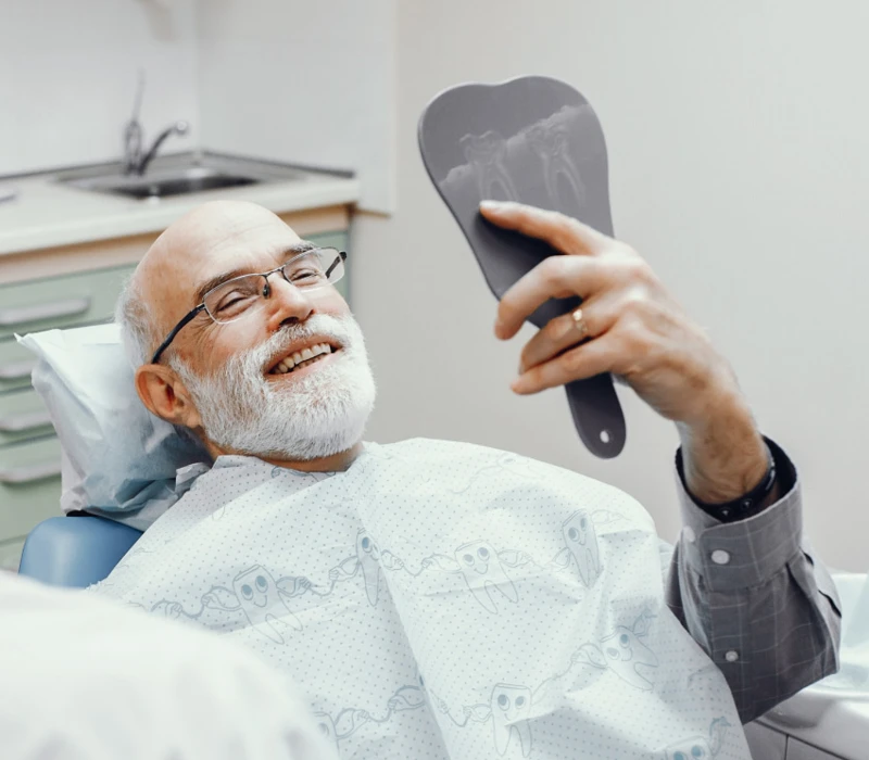 Patient smiling after getting dental implants in Coral Gables at our dental office, University Dental Group.