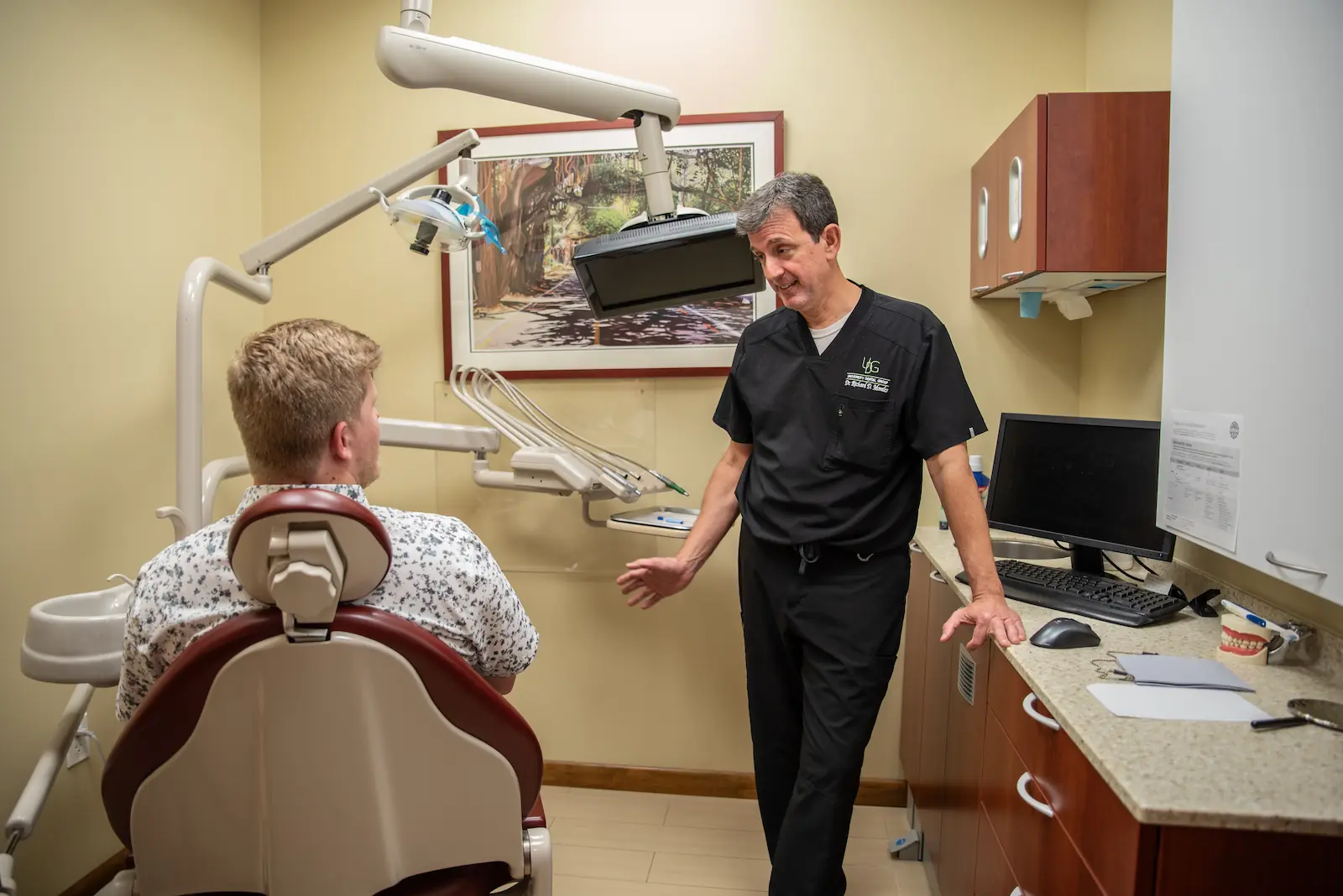 Dr. Morales talking to a patient about dental implants in Coral Gables, FL